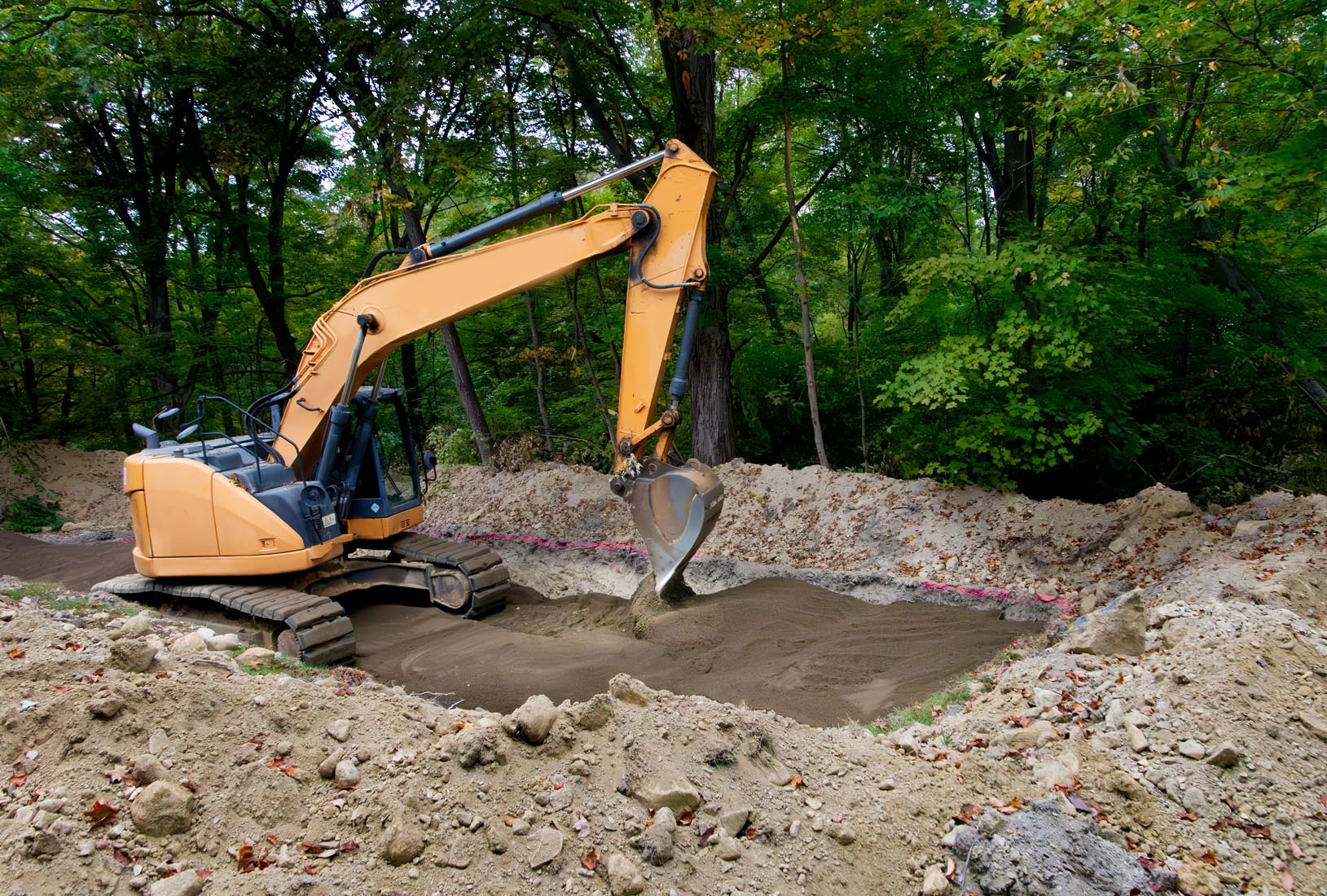 Backhoe Leveling Sand That Has Been Laid As The Bottom Level Of